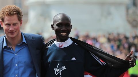 Prince Harry is flanked by the London Marathon winners Wilson Kipsang and Mary Keitany.