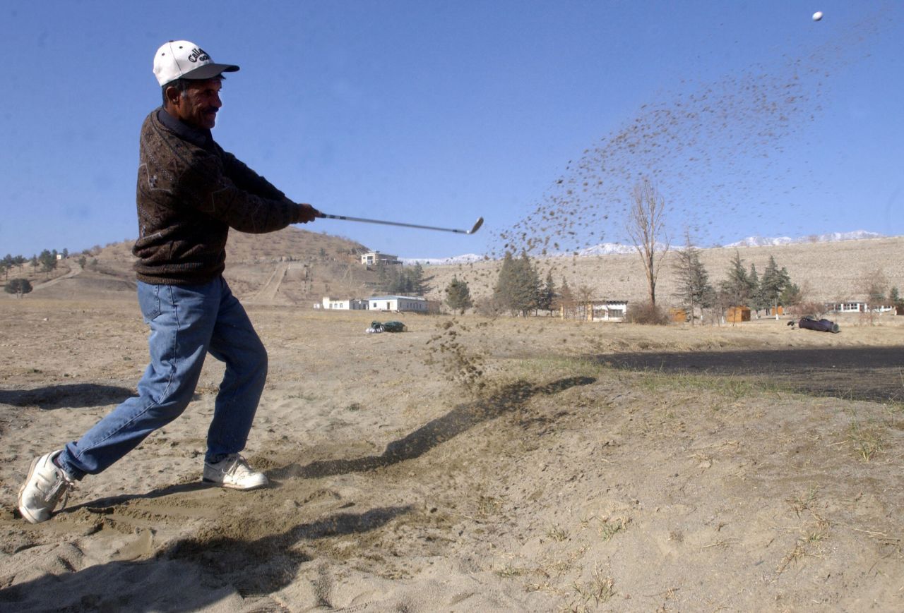 An Afghan player takes a swing during a tournament at the Kabul Golf Club. The nine-hole course, which first opened in 1967, became a battlefield in the 1990s when rival Mujahideen factions fought among themselves after overthrowing a Soviet-backed regime. 