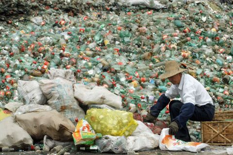 A worker packs recyclable bottles at a dump in the city of Changde in Hunan Province in southeastern China. China has increased efforts to recycle of waste materials as part its efforts to reduce pollution and protect limited natural resources.
