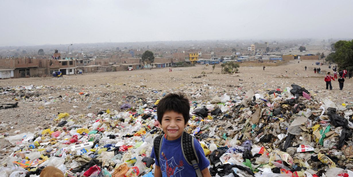 A Peruvian schoolboy smiles for the camera as he stands in a garbage dump -- one of Latin America's largest -- in the Villa el Salvador district on the outskirts of Lima. 