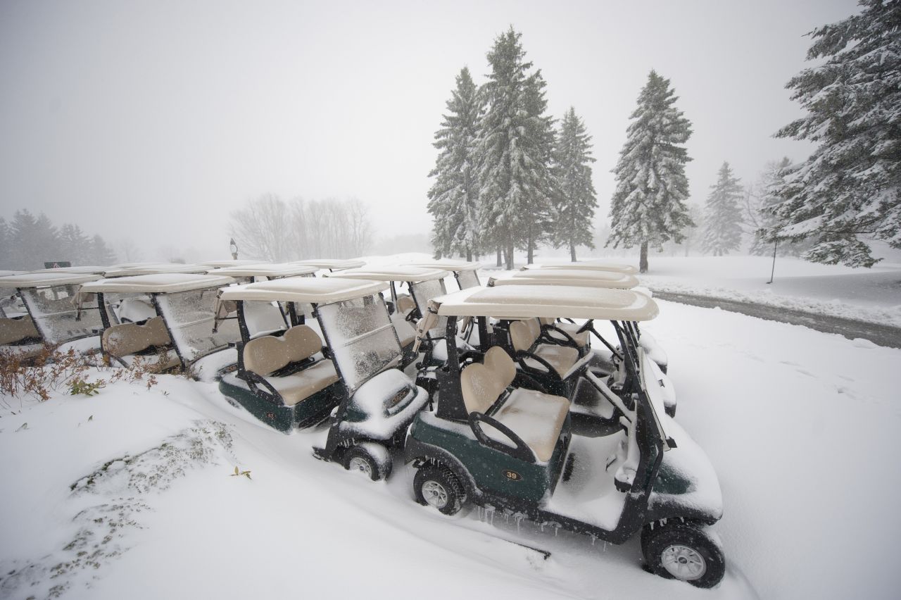 Golf carts sit under a blanket of snow at the Seven Springs Golf Course.