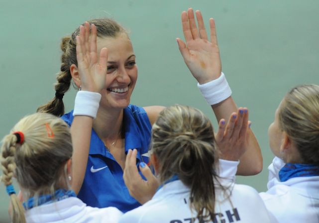 The Czech Republic's Petra Kvitova high-fives her teammates after defeating Italy's Francesca Schiavone as the defending champions won 4-1 in the other semifinal.