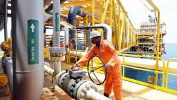 A worker inspect facilities on an upstream oil drilling platform at the Total oil platform at Amenem, 35 kilometers away from Port Harcourt in the Niger Delta.