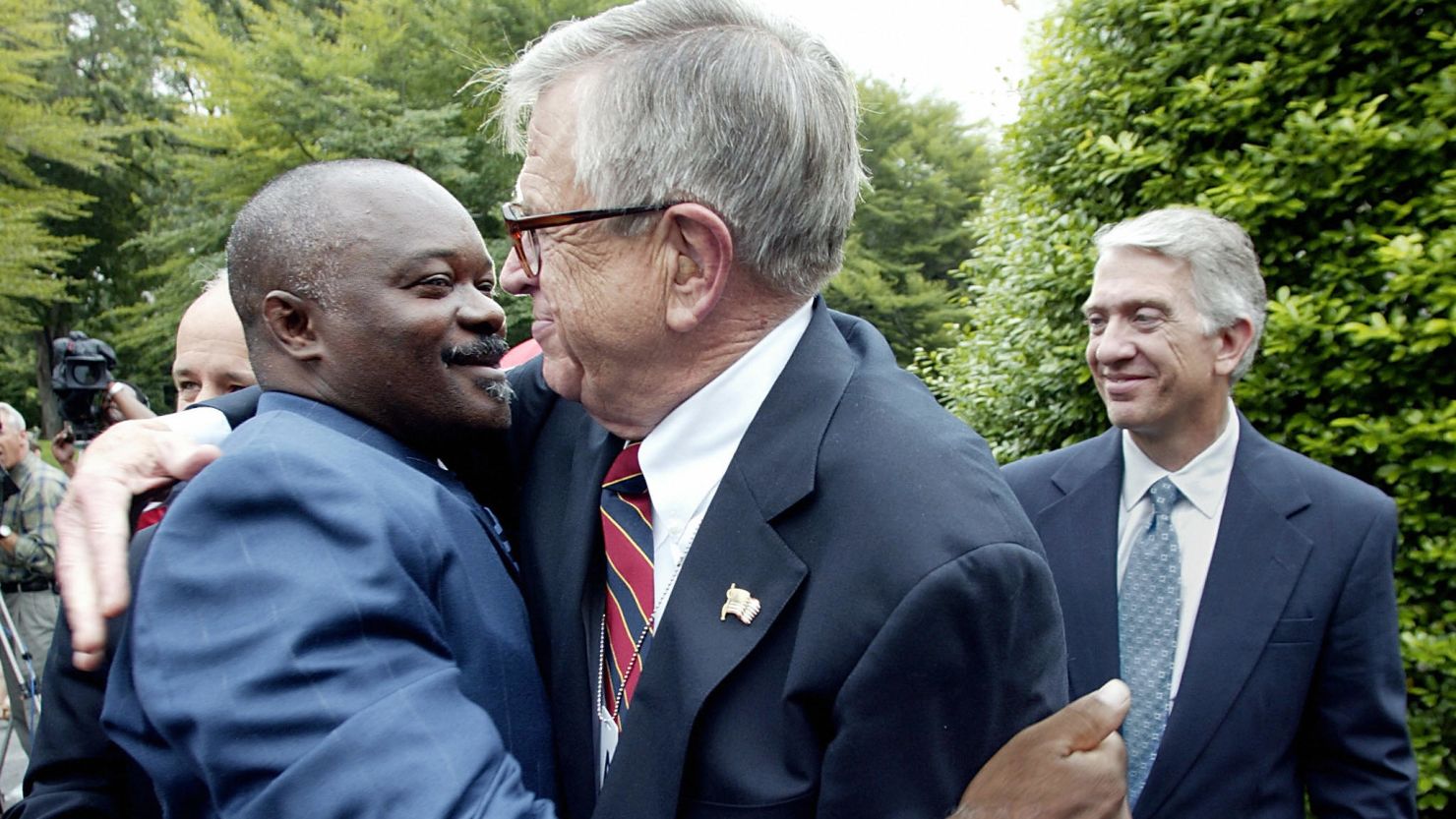 Former inmate Robert Sutten, left, hugs Chuck Colson, founder of Prison Fellowship, at the White House in 2003.