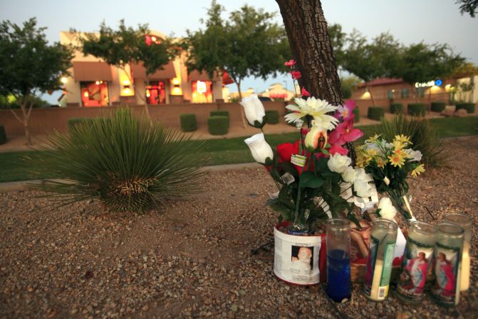 The family placed a memorial on the dirt path outside the Taco Bell where he was killed April 3.