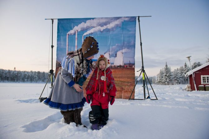 Dressed in their rich and colourful traditional clothing, Moukarzel positioned his subjects against the intentionally incongruous image of a large, smoke-chugging factory.