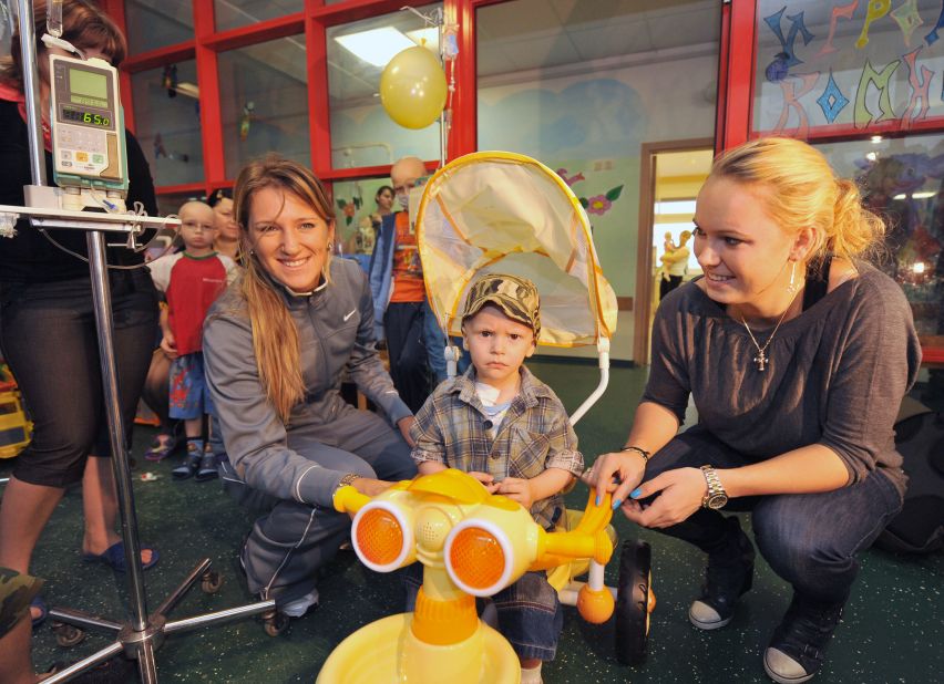 However, she still considers the Eastern European nation to be her home. Azarenka is pictured with former No. 1 Caroline Wozniacki (right) at a children's cancer center in Minsk in 2010.