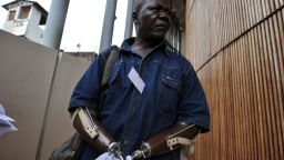 Sierra Leonian amputee association chairman Alhaji Jusu Jarka walks outside the Special Court in Freetown on April 26, 2012.