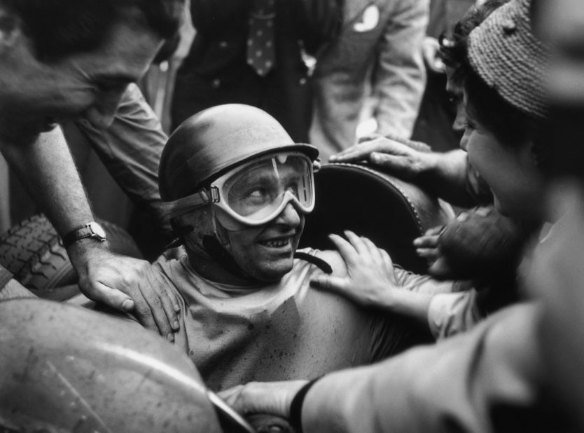 Fangio is mobbed by fans after winning the 1955 Italian Grand Prix. The racing legend had 24 wins and five world championships in a career spanning almost 20 years.