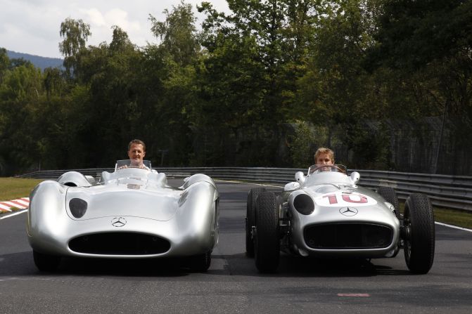 Michael Schumacher in the modern Silver Arrow while Mercedes teammate Nico Rosberg takes the wheel of the 1955 model. 