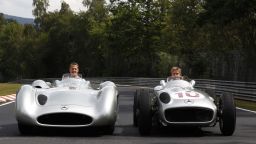Michael Schumacher in the modern Silver Arrow while Mercedes teammate Nico Rosberg takes the wheel of the 1955 model. 