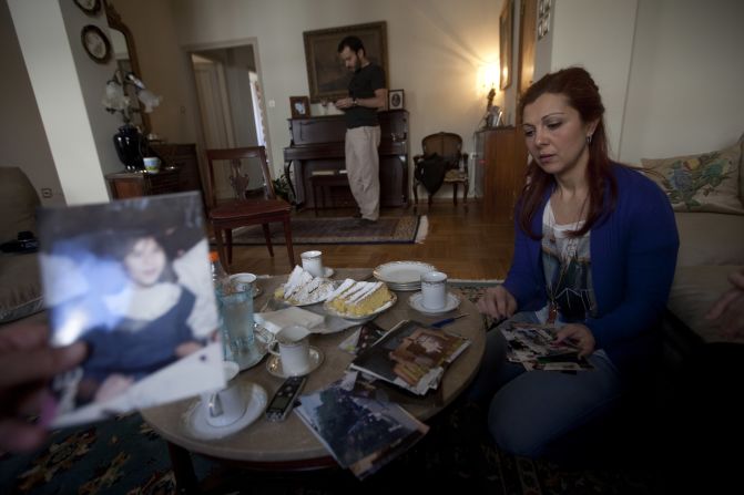 Sissy Papathanasopoulou with photographs of Angeliki. Her younger sister, four months pregnant when she died, was "very happy," Sissy says.