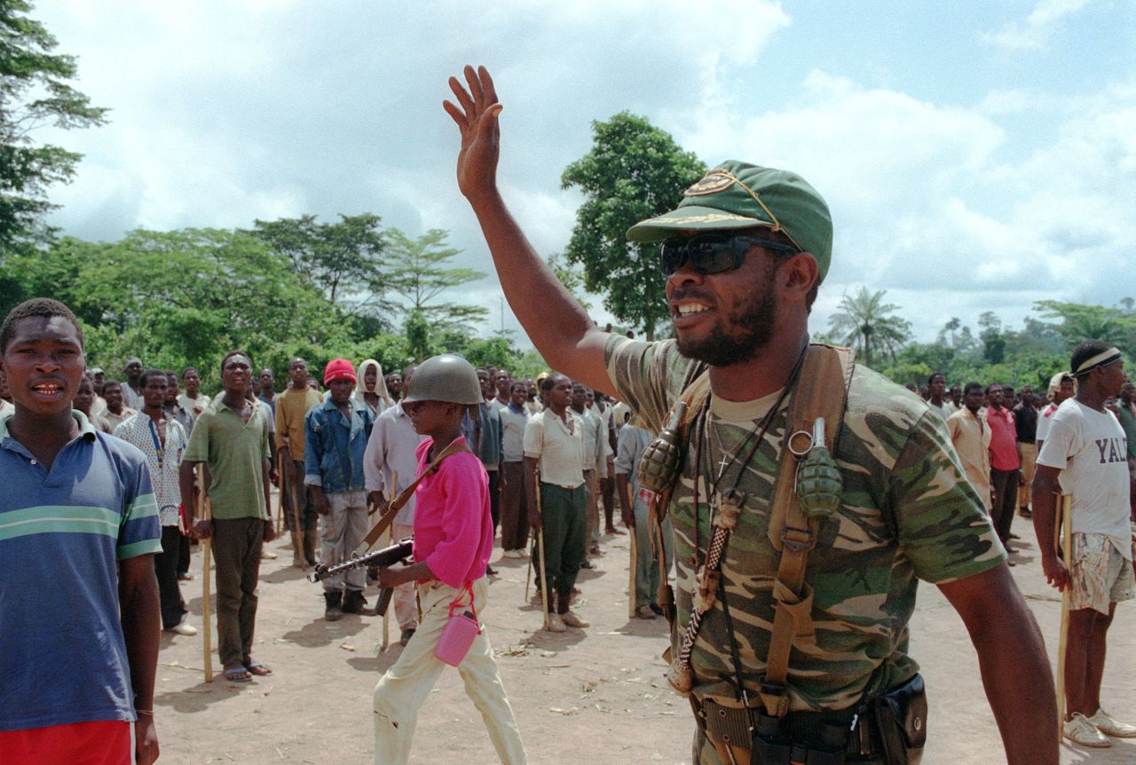 Charles Taylor, leader of the rebel National Patriotic Front of Liberia (NPFL) waves to recruits 28 May 1990 upon seizing the port of Buchanan, 200 kms (120 miles) from the capital Monrovia.