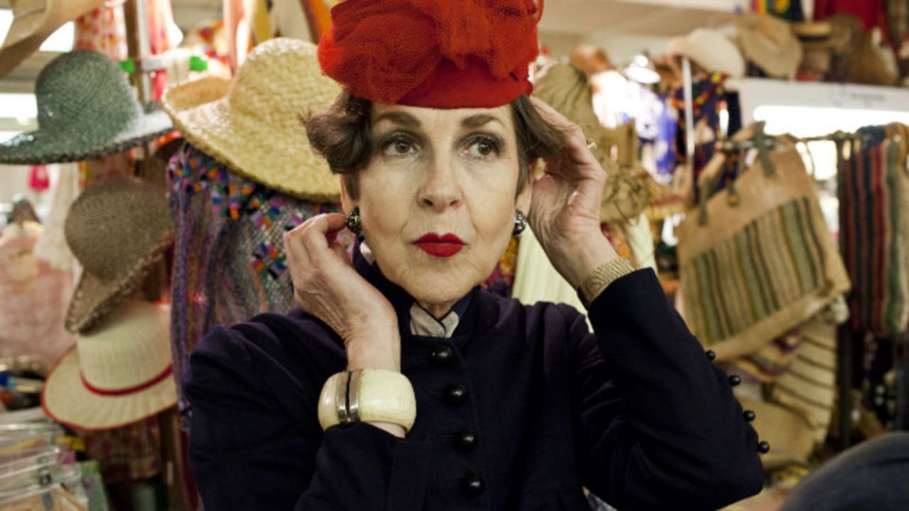Tziporah Salamon, 62, tries on a hat at the Manhattan Vintage Clothing Show.
