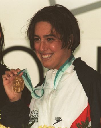 A 23-year-old Evans shows off her gold medal after winning the 800 meter freestyle at the World Swimming Championships in Rome, 1994. She was known for her "unorthodox windmill" stroke, as she puts it.