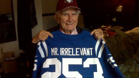 Paul Salata holds up this year's Mr. Irrelevant jersey in a New York hotel room.