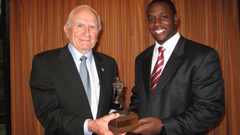 Salata presents the Houston Texans' Cheta Ozougwu with the 2011 honor last year.