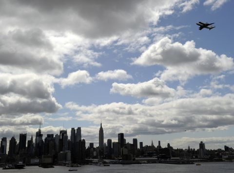 The Enterprise makes its way up the Hudson River while mounted on the shuttle carrier aircraft on its final flight Friday.