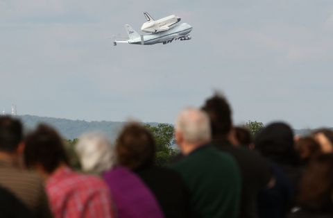 People watch as the 747 takes off with the shuttle at Washington Dulles International Airport on Friday.
