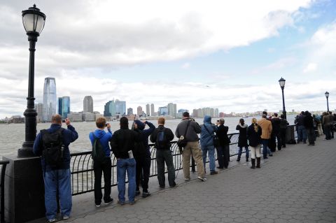 People watch the Enterprise space shuttle fly past the New Jersey skyline in its final flight.