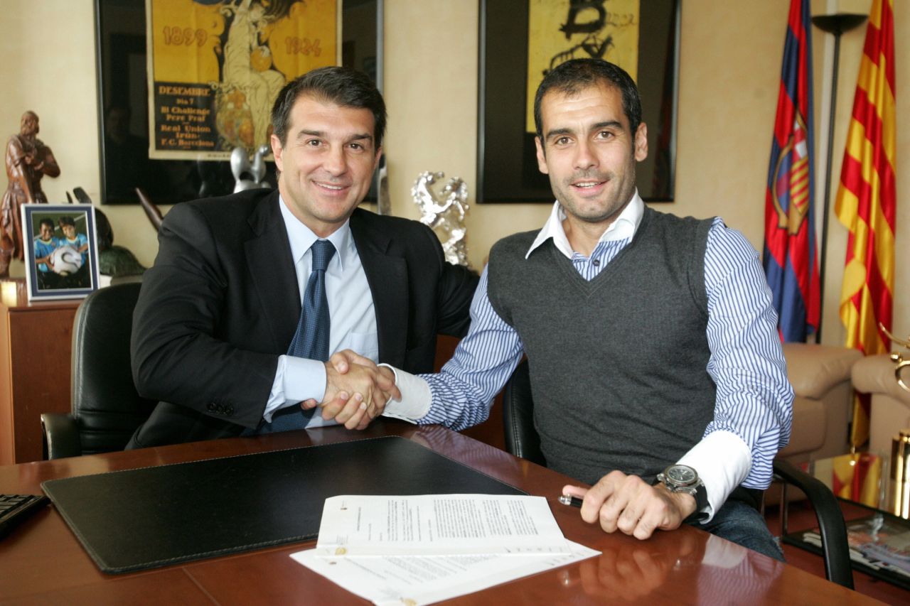 Former Barcelona president Joan Laporta shakes hands with Guardiola on June 5, 2008. The Catalan club's 15th coach arrived with the mission to end a two-season trophy drought -- he didn't disappoint.
