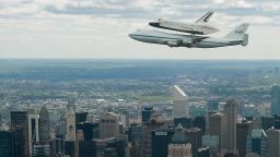  In this image provided by NASA, the space shuttle Enterprise, mounted atop a NASA 747 Shuttle Carrier Aircraft (SCA), flies near the Intrepid Sea, Air and Space Museum, April 27, 2012, in New York City. 