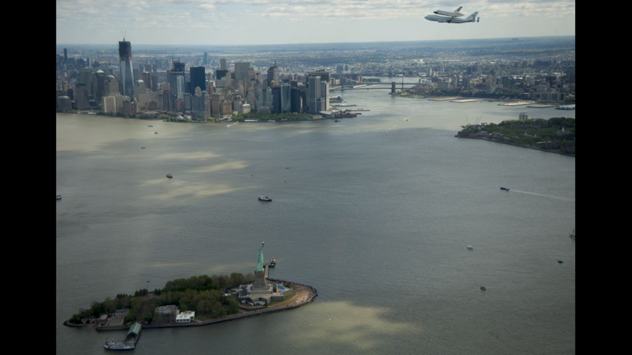 The space shuttle Enterpise flies over the Hudson River.
