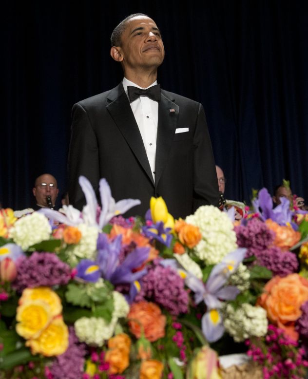 President Barack Obama stands during the opening of the White House Correspondents' Association Dinner on Saturday, April 28, 2012.