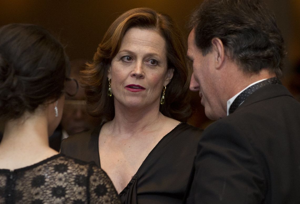 Actress Sigourney Weaver and former Republican presidential hopeful Rick Santorum, right, socialize at the dinner. 