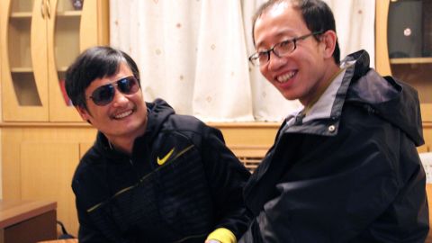 This undated photo shows outspoken government critic Hu Jia, right, sharing a light moment with blind lawyer Chen Guangcheng after his escape, at an undisclosed location in Beijing.