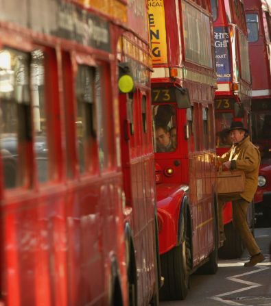 A double-decker Routemaster bus makes its way along a London street in 2004.