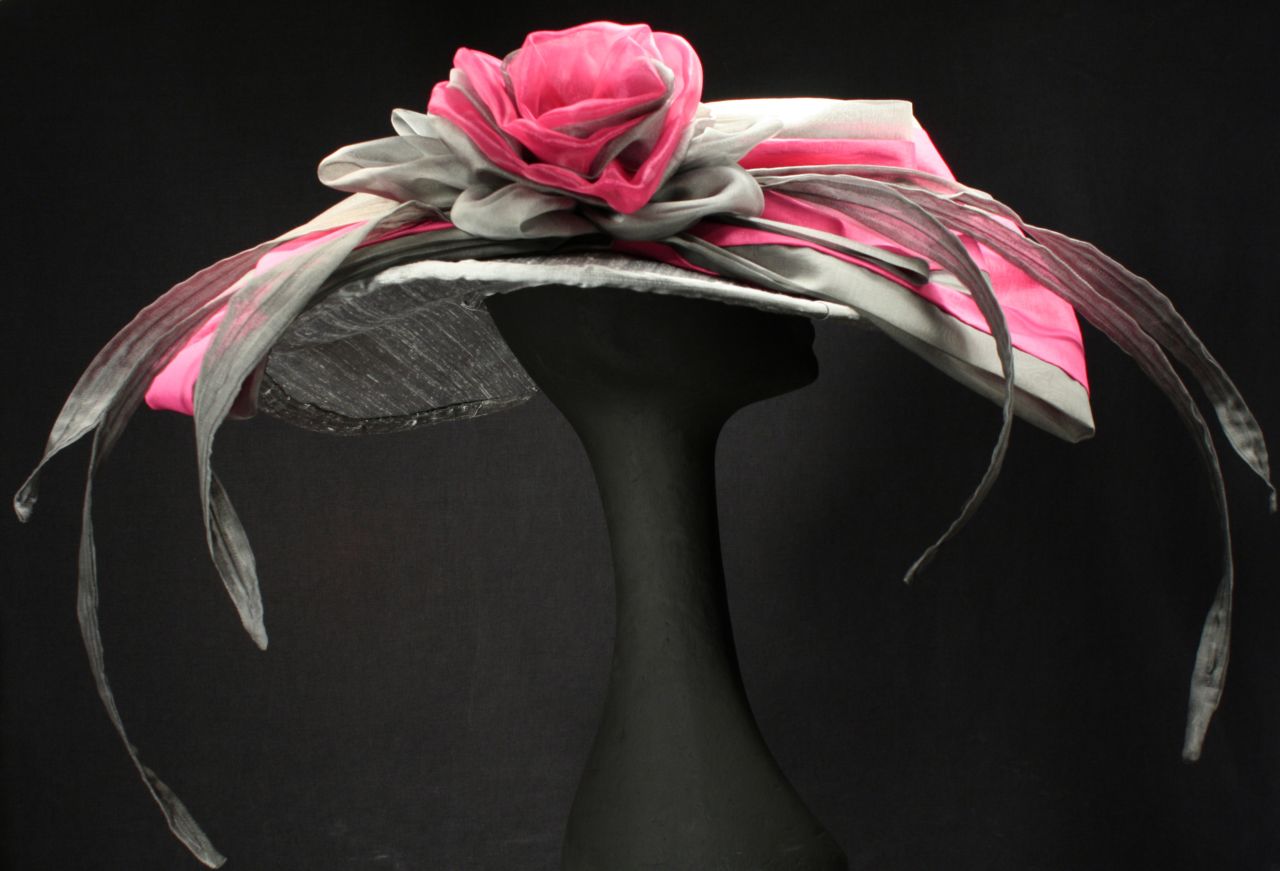 Steinmann's "Michaela" hat uses dupioni silk to create a wide brim hat, as well as a large rose curl, and one of her trademarks, several silk organza "feathers." She doesn't like to use real feathers.