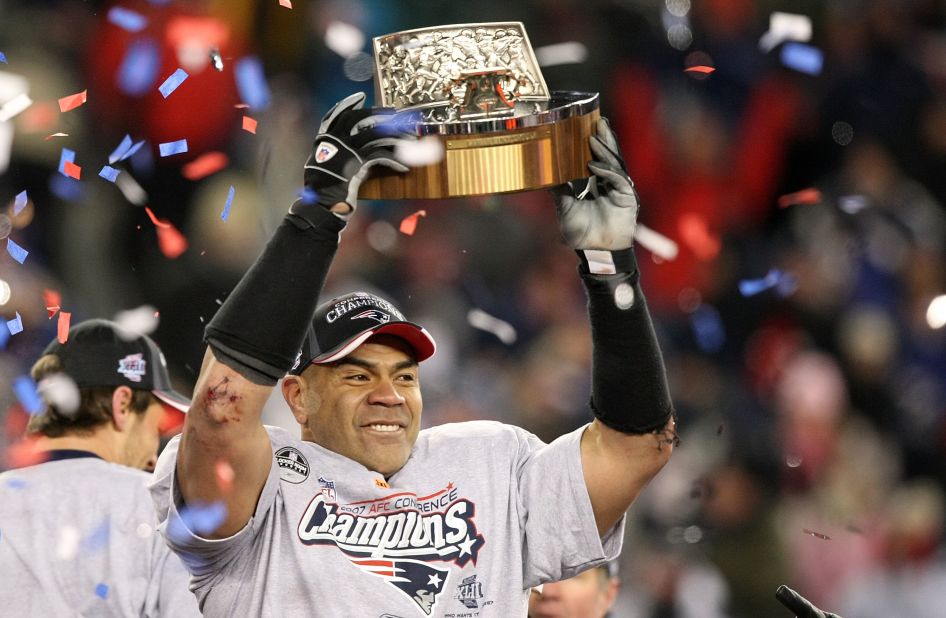 Seau lifts the Lamar Hunt AFC Championship trophy after the New England Patriots' 21-12 win over his former team, the San Diego Chargers, on January 20, 2008. Seau played the last four of his 20 seasons for the Patriots.