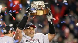 Seau lifts the Lamar Hunt AFC Championship trophy in victory after the Patriots' 21-12 win over the San Diego Chagers during the AFC Championship Game on January 20, 2008 at Gillette Stadium in Foxboro, Massachusetts.