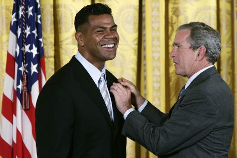 President George W. Bush presents Seau with the President's Volunteer Service Award In the East Room of the White House on May 25, 2005. The award was created to recognize Americans who have made a sustained effort to community service. 