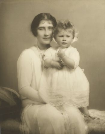 A little princess, Elizabeth II sits with her mother Queen Elizabeth.