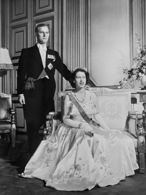 Princess Elizabeth and new husband, Prince Philip of Greece, pose for a royal photographer on their wedding day, 20 November 1947. By all accounts Prince Philip had won the future queen's heart by the age of 13. 