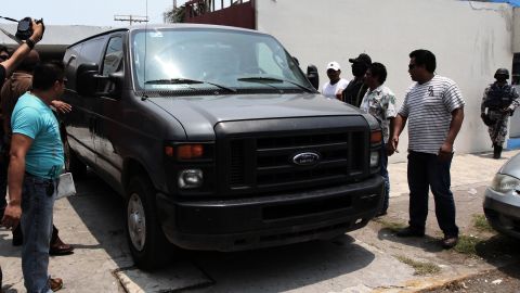 A vehicle transporting the remains of two news photographers arrives at the morgue in Veracruz, Mexico, on Thursday.