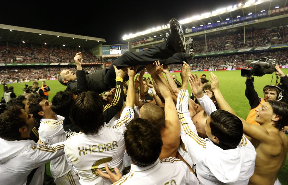 Real Madrid players lift Jose Mourinho after winning the Spanish title for the 32nd time. The Portuguese coach has also won league titles in Portugal, England and Italy.