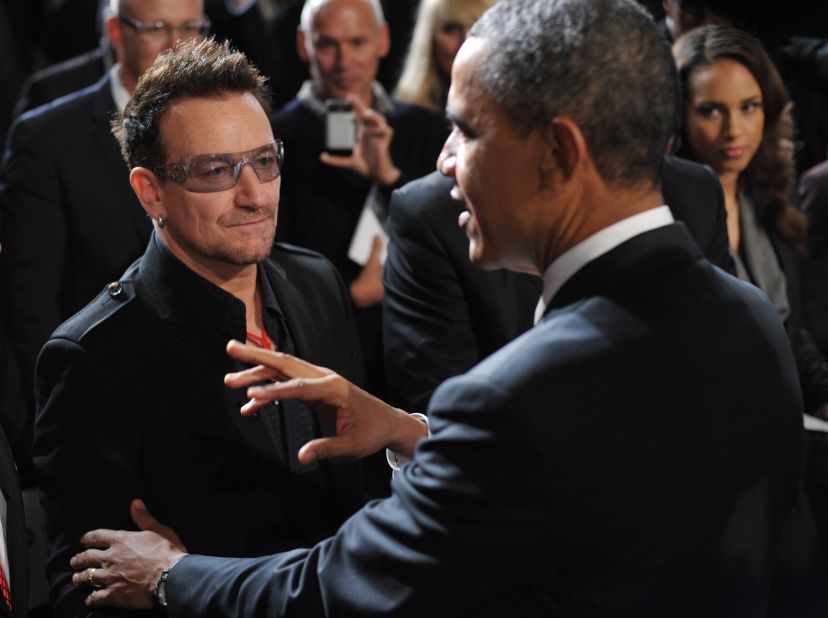 After speaking at a World AIDS Day event, Obama chats with U2's Bono as singer Alicia Keys looks on at George Washington University on December 1, 2011.