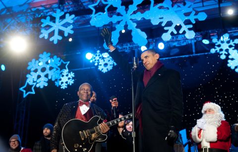 Obama waves alongside music legend B.B. King during the National Christmas Tree Lighting ceremony on December 9, 2010.