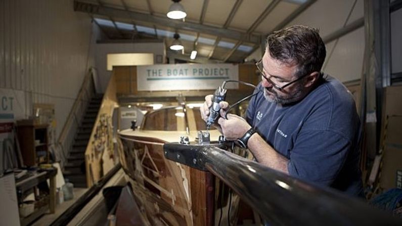 Olympian and boat builder Mark Covell makes the finishing touches to the boat.
