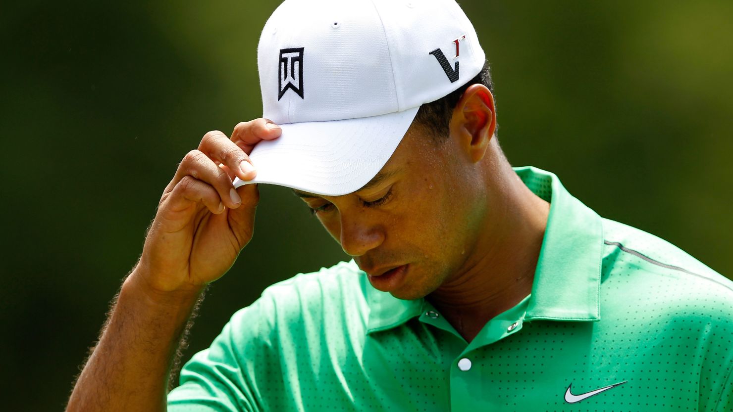 A disconsolate Tiger Woods on his way to a one-over 73 in the Quail Hollow Championship in North Carolina.