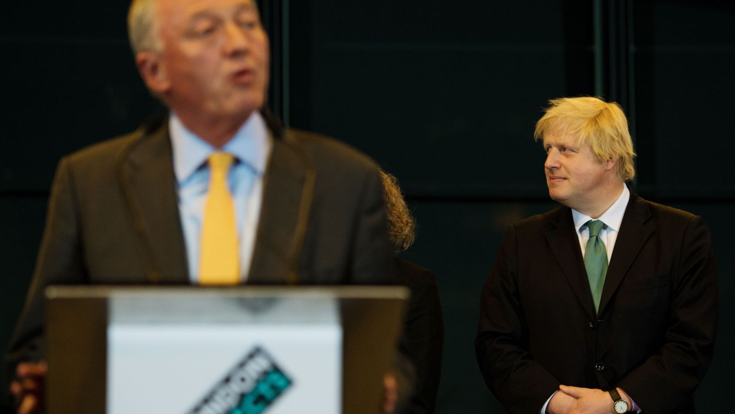 Boris Johnson (R) looks on as his main opponent Ken Livingstone speaks after the election results are announced.