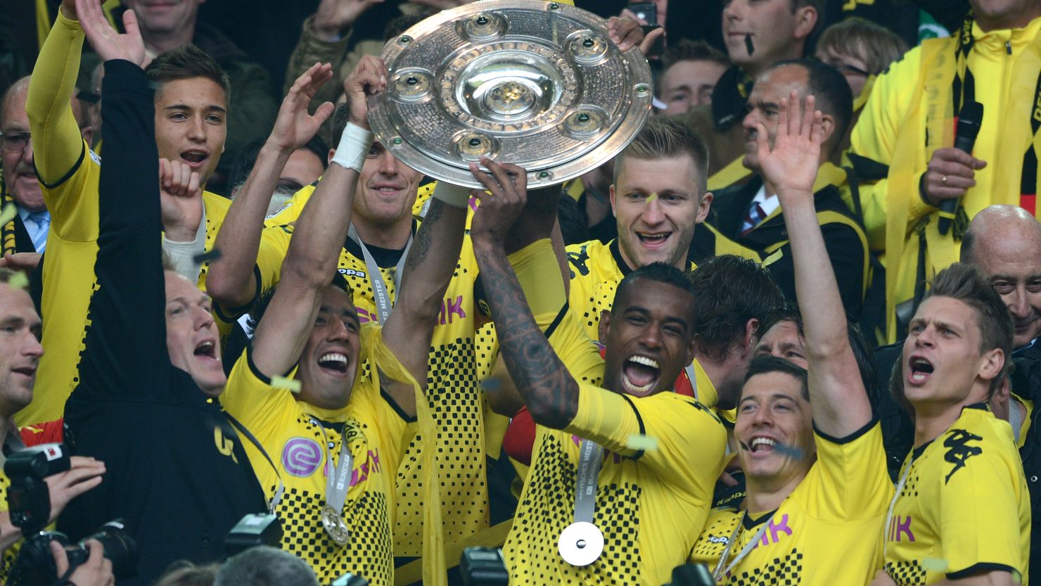 Dortmund's players lift the Bundesliga trophy after beating Freiburg 4-0 at home on Saturday.