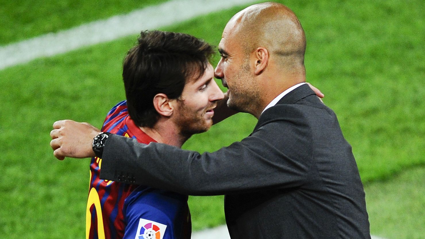 Lionel Messi hugs Barcelona coach Josep Guardiola after scoring his third goal in the derby against Espanyol.