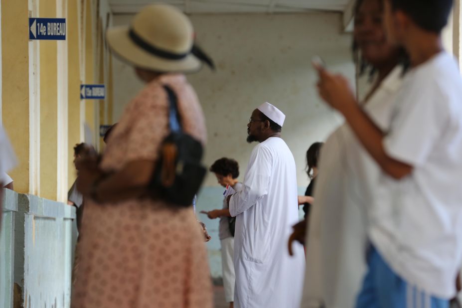 People on the French island of La Reunion in the Indian Ocean line up at a polling station in Saint-Denis. Voter turnout was reported at 73%.