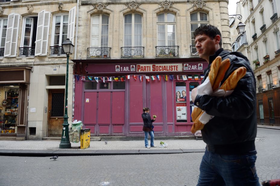 A man walks past a local office of the Socialist Party in Paris on Saturday, the day before the presidential runoff.