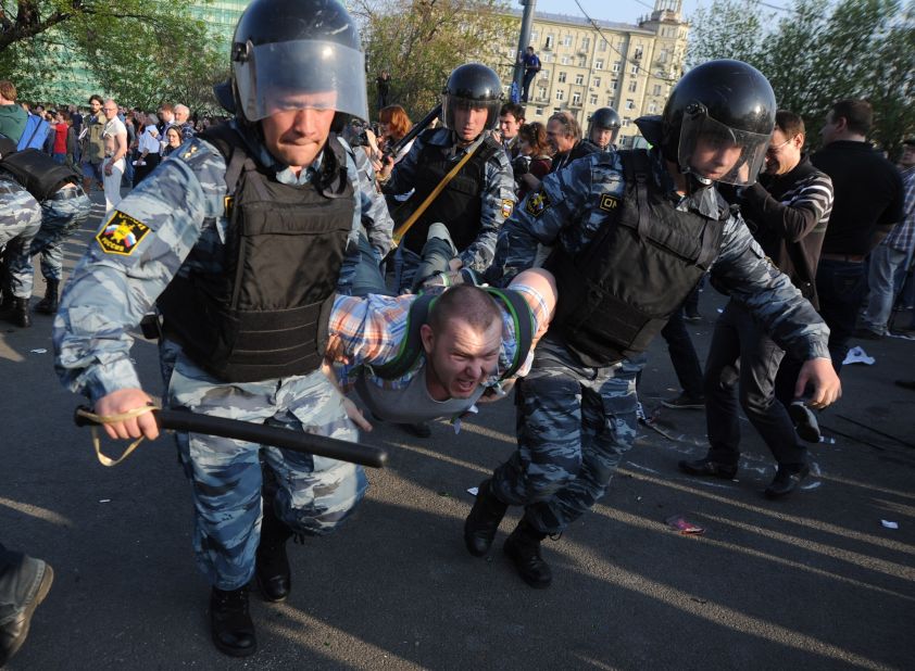 Russian police detain a protester during a rally in Moscow on Sunday, May 6, the eve of Vladimir Putin's return as president.