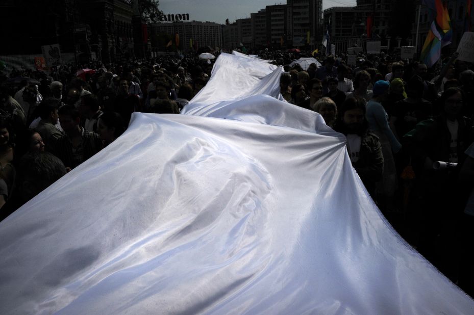 Demonstrators carry a giant white ribbon as they march on Sunday. In Russia, the white ribbon has emerged as a symbol of the opposition movement.
